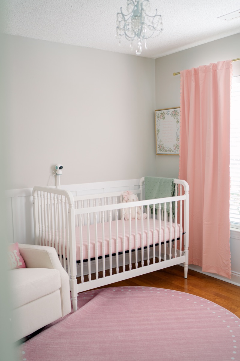 A nursery with the Nonnanest camera mounted on the crib rail.